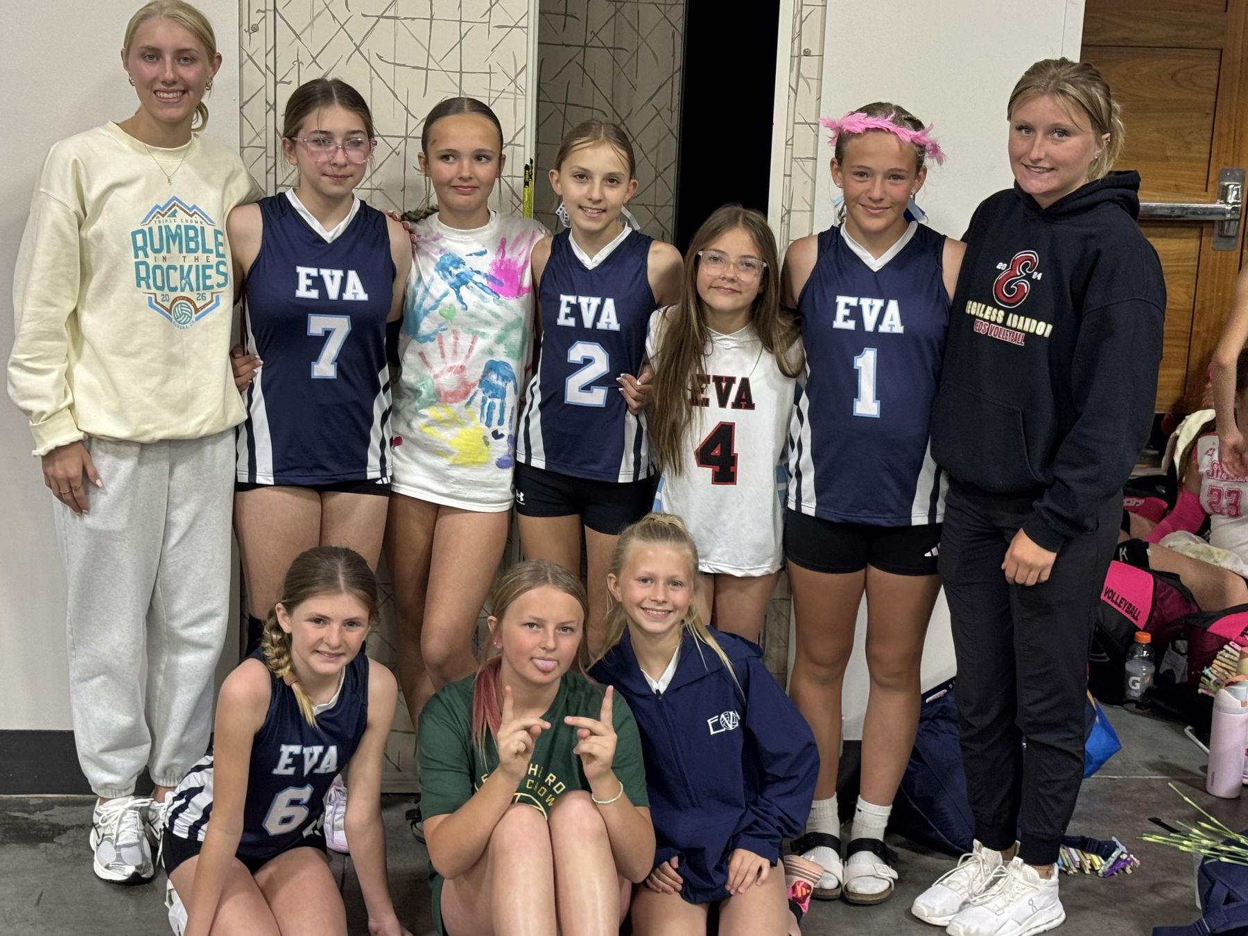 A younger EVA team poses with two coaches