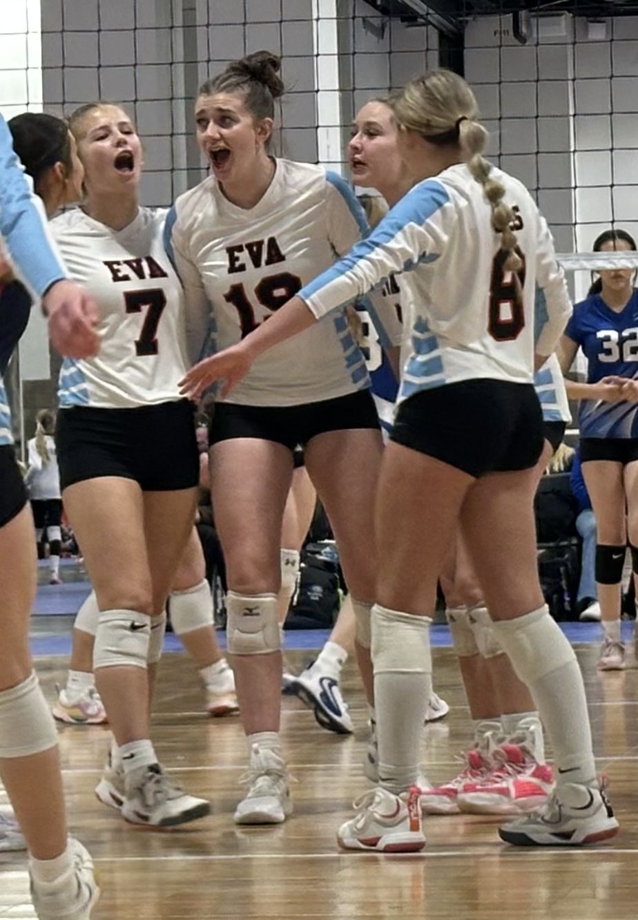 EVA players celebrate after winning a point