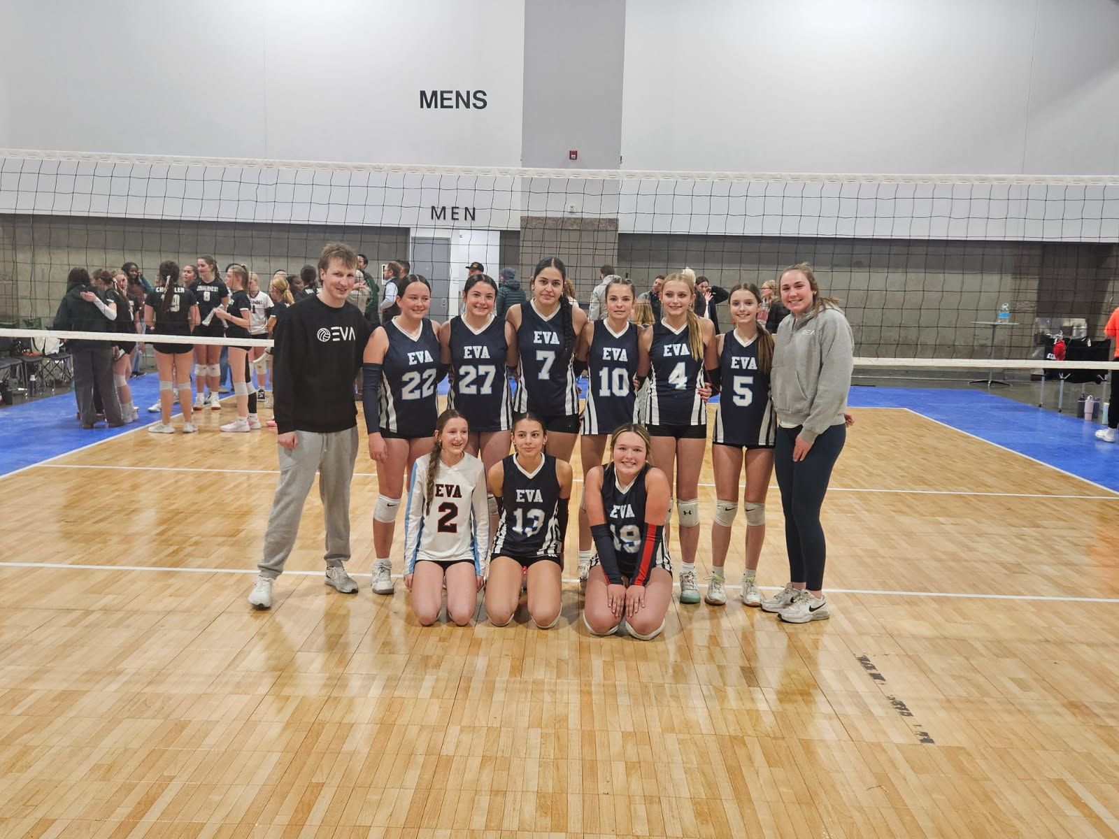 EVA team and coaches together on a tournament court